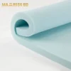Macro view of open-cell memory foam showing the blue cooling gel beads infused within the material.