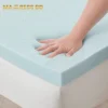 A hand pressing into a gel memory foam topper, showing the slow-rebound and contouring effect.