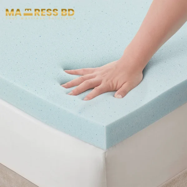 A hand pressing into a gel memory foam topper, showing the slow-rebound and contouring effect.